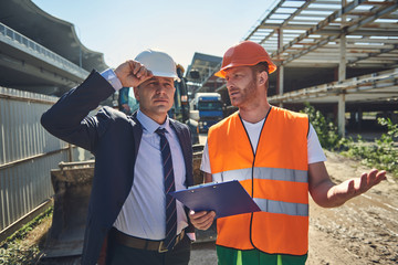 Worker man is speacking with his boss