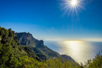 beautiful seascape and sun on blue sky background on amalfi coast