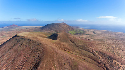 Panorama over volcanic mountains in Lanzarote, Canary Islands, Spain, aerial view .