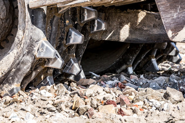 landfill compactor is leveling up stone
