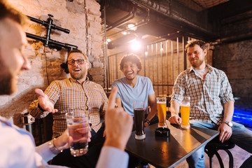 Men laughing at friend who drinking water.