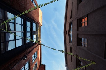 Fototapeta na wymiar Low angle view building against cloudy sky, symmetry old street