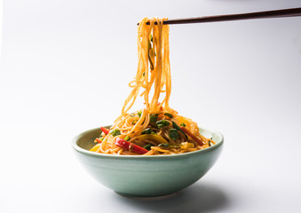 Schezwan Noodles or vegetable Hakka Noodles or chow mein is a popular Indo-Chinese recipes, served...