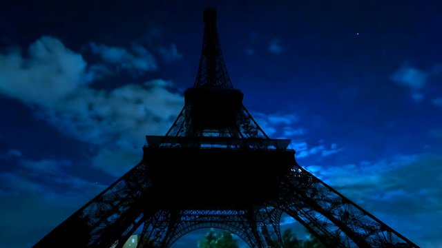 TIME LAPSE: dark sky with moving clouds, the full moon shining and moving clouds at night with backlit Eiffel Tower. Paris in France.
