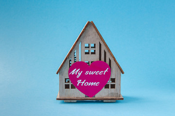 wooden house with heart concept of family, love in home, comfort, gift, valentine's day on pastel...