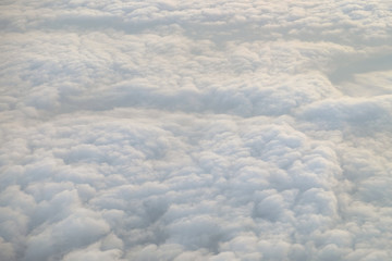 Soft and fluffy white clouds, view from the airplane above the sky
