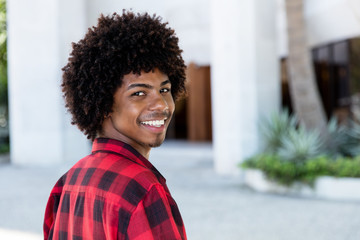 Fototapeta premium Laughing african american hipster man with afro hairstyle