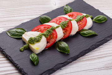 Caprese salad on a wooden rustic background