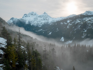 A moody sunrise over snow capped alpine peaks