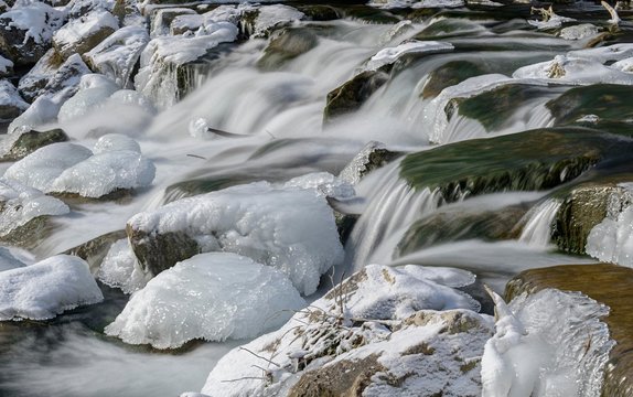 Ice-covered stones in the river bed of the Triesting, Pottenstein, Lower Austria, Austria, Europe