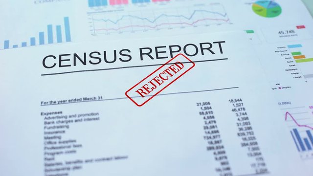 Census report rejected, hand stamping seal on official document, statistics