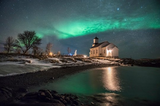 Northern lights over church of Gimsoy, Norway