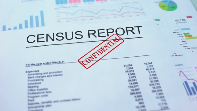 Census report confidential, hand stamping seal on official document, statistics