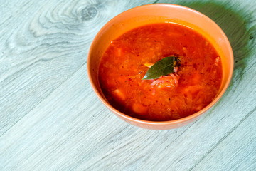 Traditional Ukrainian Russian vegetable borscht on red bowl. Flat lay. Top view. Wooden background