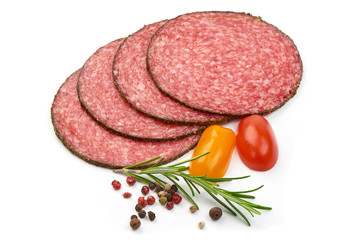 Italian Semi-dry Sliced Sausage with herbs, spices and tomatoes, isolated on a white background. Close-up