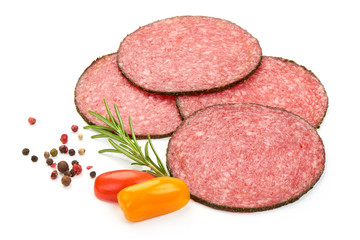 Salami Smoked Sausage Slices with herbs, spices and tomatoes, isolated on a white background. Close-up