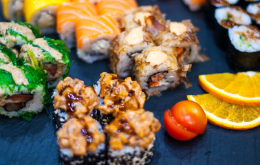 Sushi Set nigiri and sushi rolls on gray stone slate on metal background
