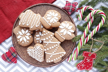 Christmas background. Spiced Gingerbread Cookies with Frosting and Candy Cane