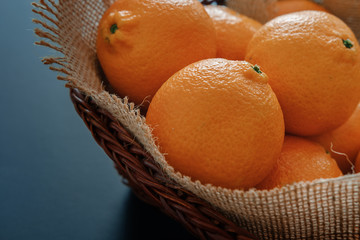 Tangerines (clementines) in wicker basket with burlap - 237623902