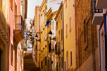 Fototapeta na wymiar Cozy street of the old European city Relleu. Mediterranean architecture in Spain.
