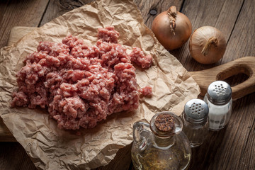 Minced meat on wooden background.