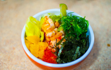 Sushi Set sashimi and sushi rolls served on stone slate