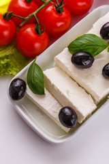 A piece of feta cheese on a white background