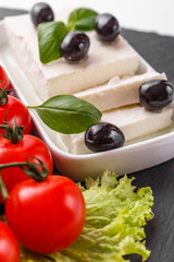 A piece of feta cheese on a white background