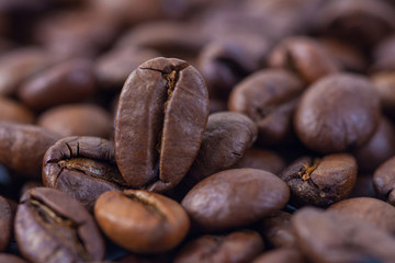 Roasted coffee beens on a wooden table, close up