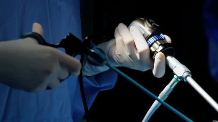 Laparoscopy surgical operation surgeons using Endoscopy and Laparoscope instruments wearing surgical gloves and scrubs  - Powered by Adobe