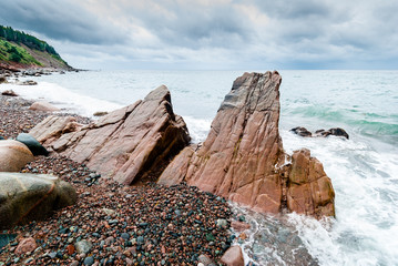 Scenic shoreline of Nova Scotia rocky beach on a rainy stormy day.