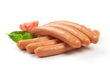 Fresh boiled Wiener sausages with green herbs and vegetables isolated on the white background.