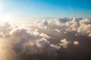 Top aerial view background on blue sky, bright sun white clouds 