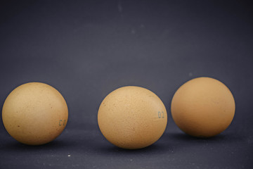 chicken eggs on black background