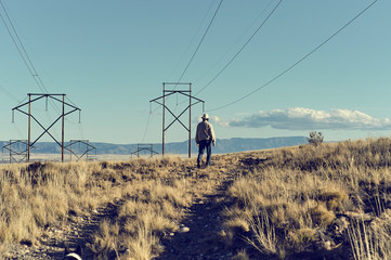 Man walking under Powerlines