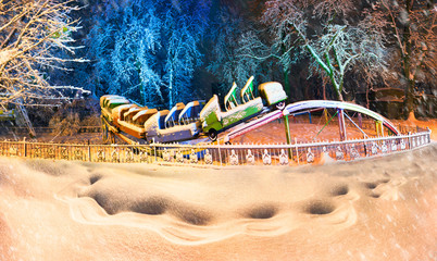 Snow-covered attractions in the old park