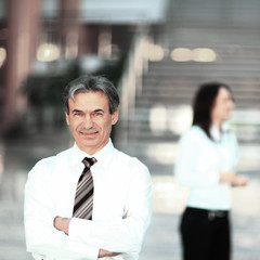 portrait of a senior businessman on blurred background office