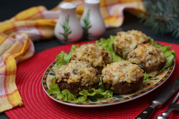 Stuffed champignons with mozzarella cheese, vegetables and bulgur, appetizer on a festive table, close up, horizontal