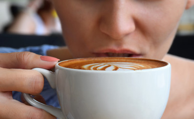 Woman drinking from a coffee cup