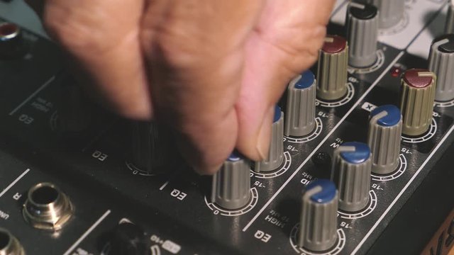 Man Adjusts To The Control Panel Of The Sound Music Mixer