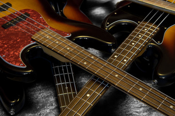 Fototapeta na wymiar Bass guitars stacked in disarray