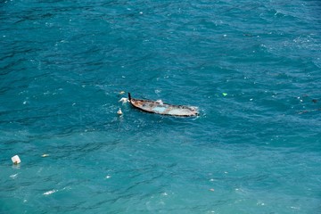 Fototapeta premium Half sunken boat at Cinque Terre in Monterosso al mare, Italy