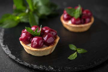 Pastry tart. Delicate crispy, crumbly dessert with cherry in its own juice and mint. Assorted Confectionery Range.
