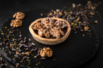 Сake сhocolate tart. Delicate crispy, crumbly dessert with nuts. Assorted Confectionery Range.