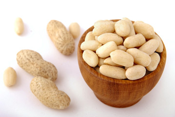 Raw peanut peeled in a bowl on white isolate.
