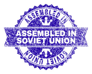 ASSEMBLED IN SOVIET UNION rosette stamp imprint with grunge texture. Designed with round rosette, ribbon and small crowns.