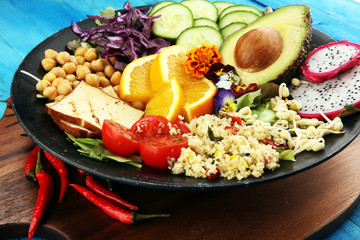 grilled tofu and dragon fruit buddha bowl with vegetable and humus