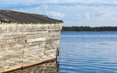 Old Wooden Boathouse On The River In Summer