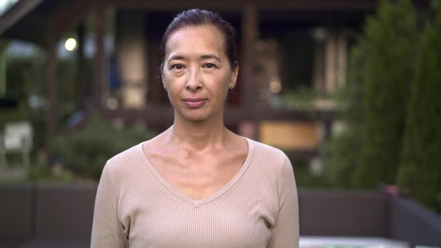 Middle aged asian woman saying no and gesturing