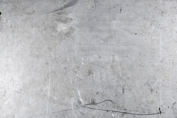 Grey grunge scratched metal sheet background. Worn steel surface texture